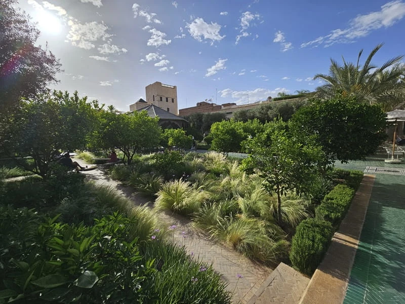 Landscaped gardens in Marrakech with palm trees and seating areas